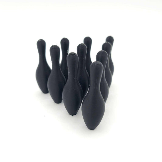 Set of 10 black 3D-printed mini bowling pins arranged in a triangular formation for desk or tabletop games