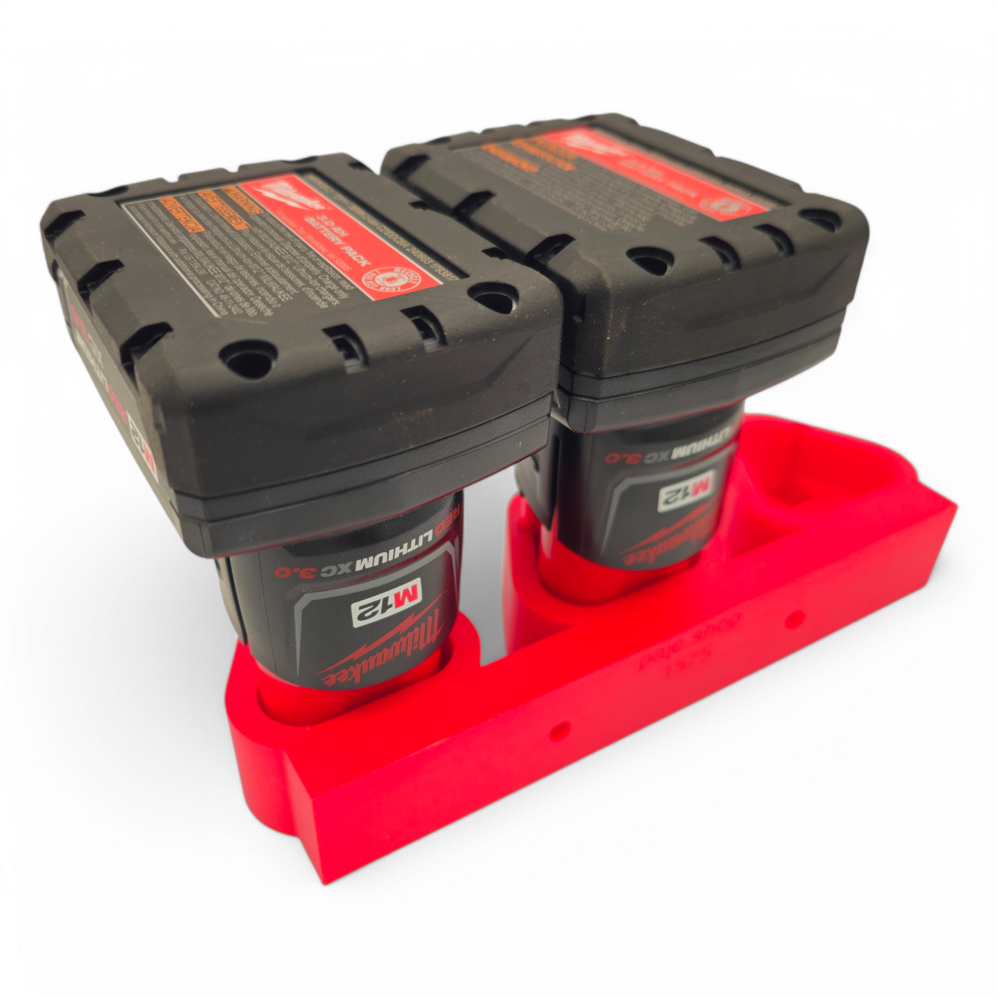 Red Milwaukee M12 battery holder mount holding two M12 batteries for wall storage and organization