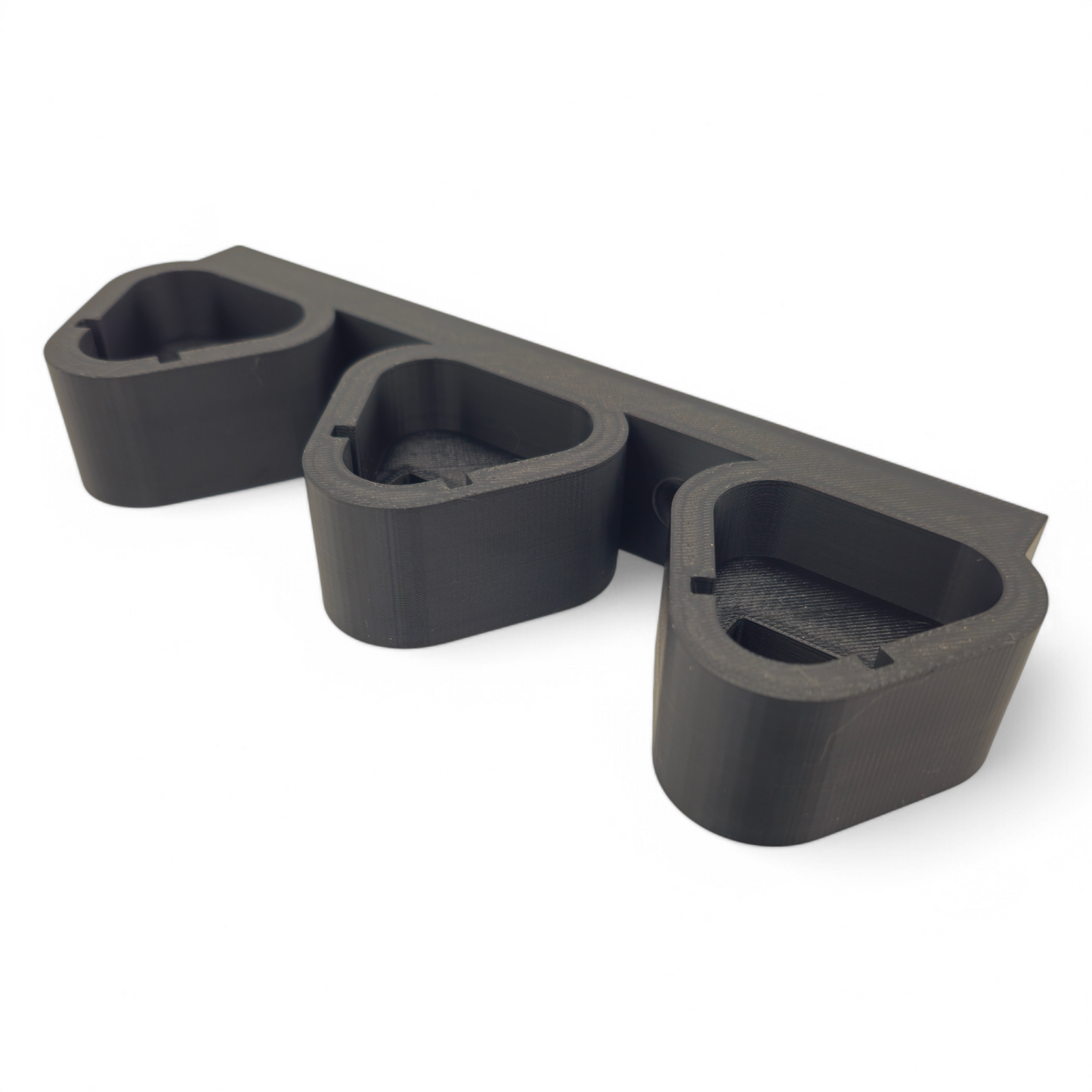 Black 3-slot wall mount holder for Milwaukee M12 batteries made from durable PETG, fits all battery sizes and mounts with two screws.