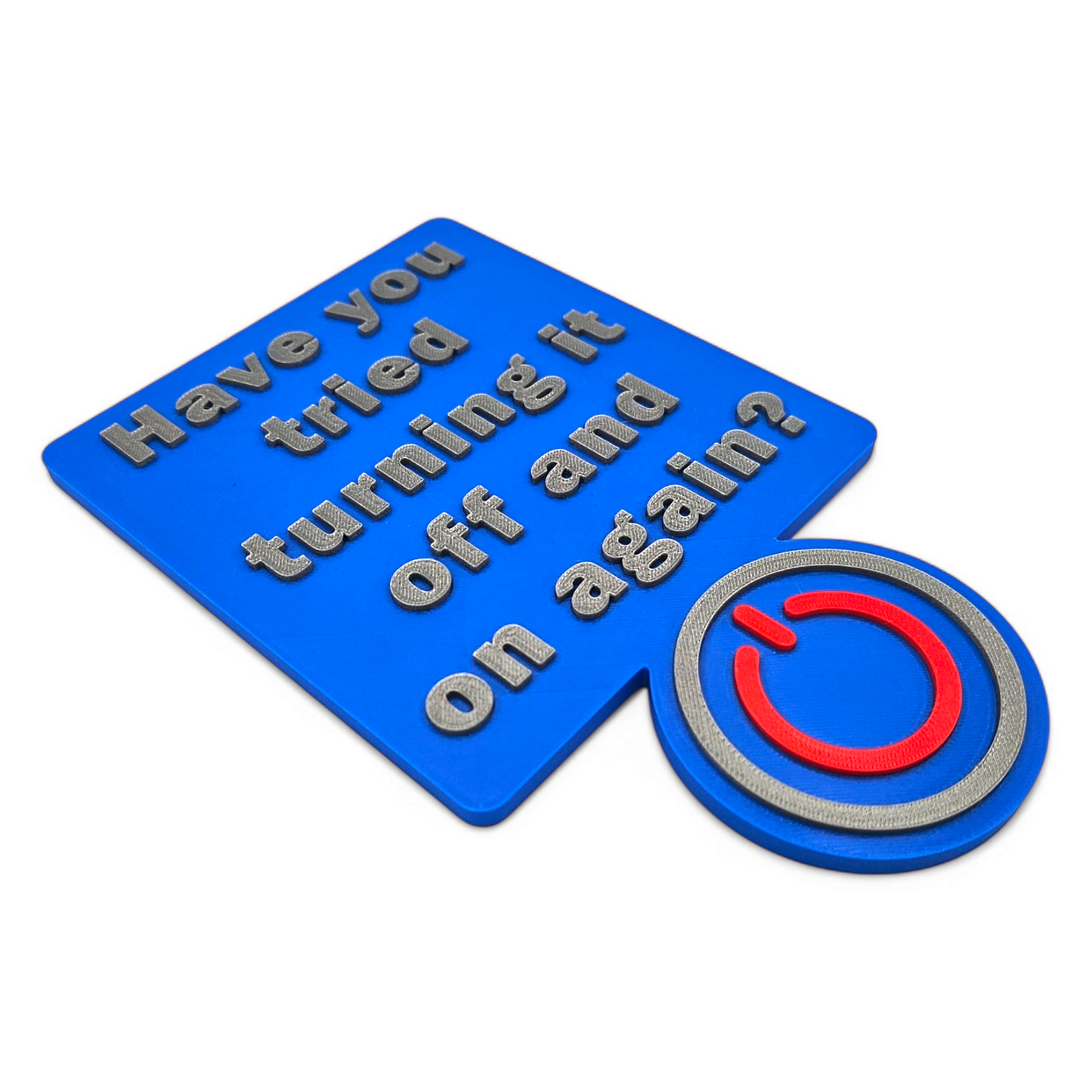 3D printed "Have You Tried Turning It Off and On Again" sign with raised silver lettering and a red and silver power button on a blue background for tech decor