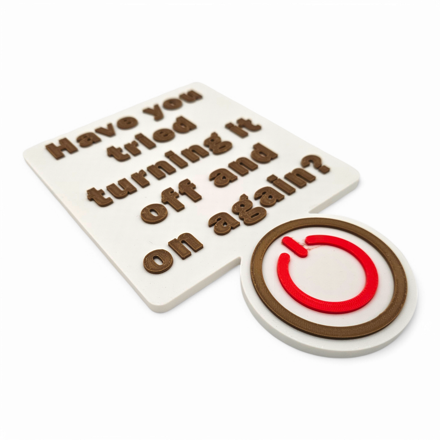3D printed "Have You Tried Turning It Off and On Again" sign with raised brown lettering and a red power button on white background for tech decor