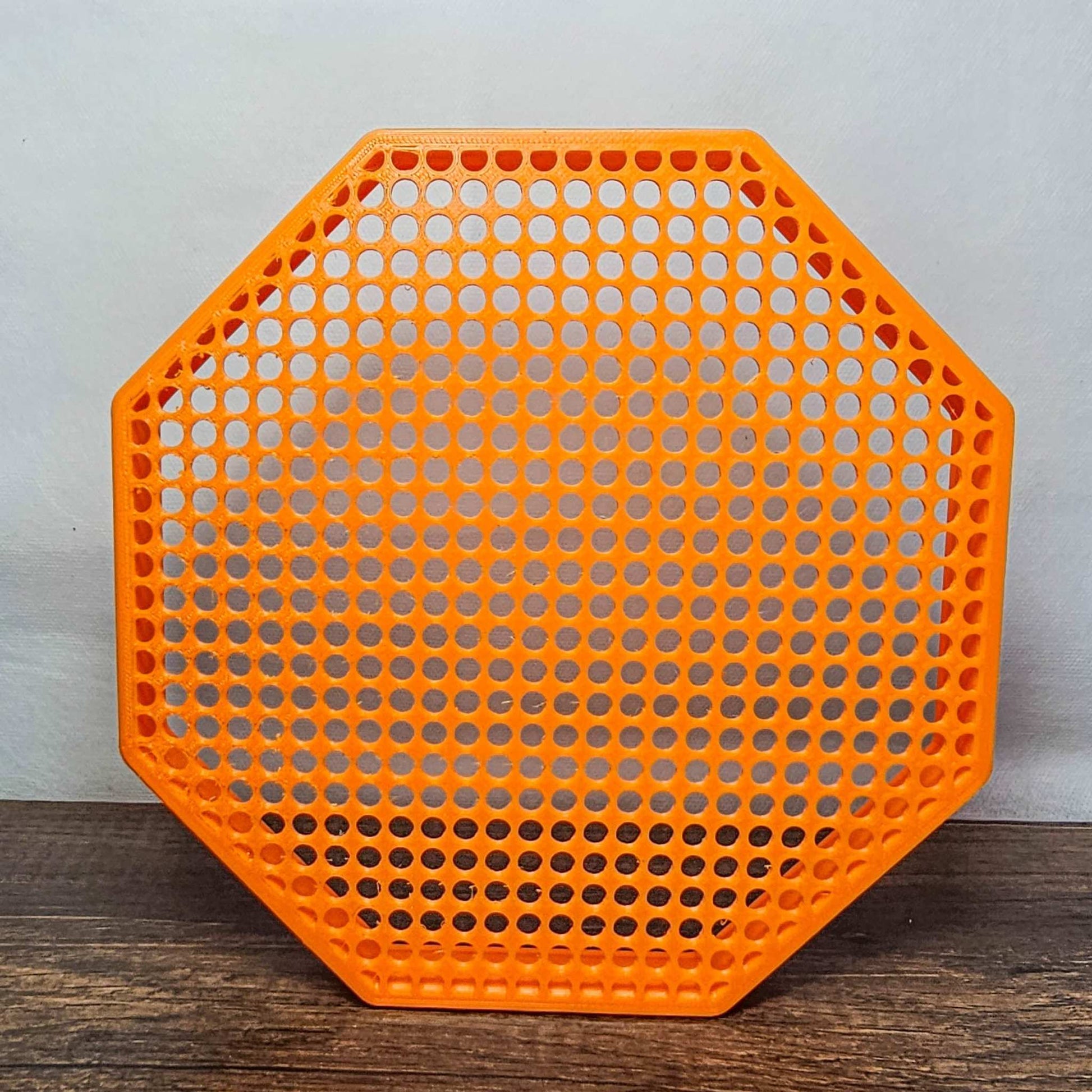 8" orange octagon enamel pin board display with perforated surface for mounting pins, wall mount or self-standing design