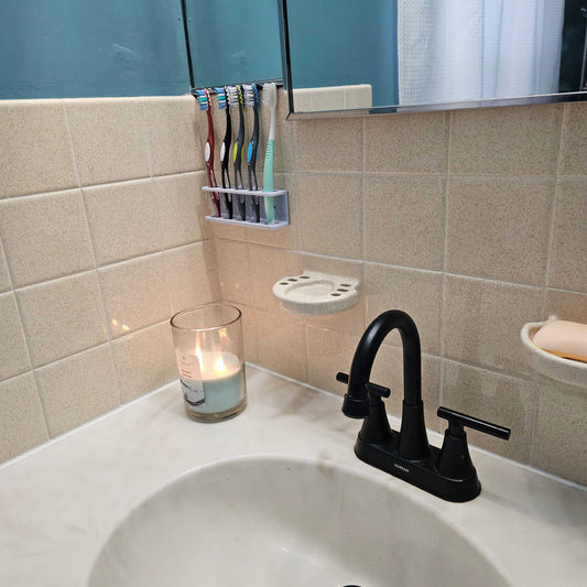 3D printable wall-mounted toothbrush holder organizing multiple toothbrushes above bathroom sink