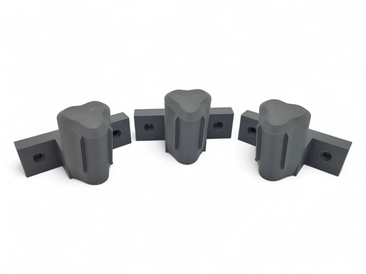 Set of three wall mounts for Milwaukee M12 tools, shown in a secure and organized arrangement.