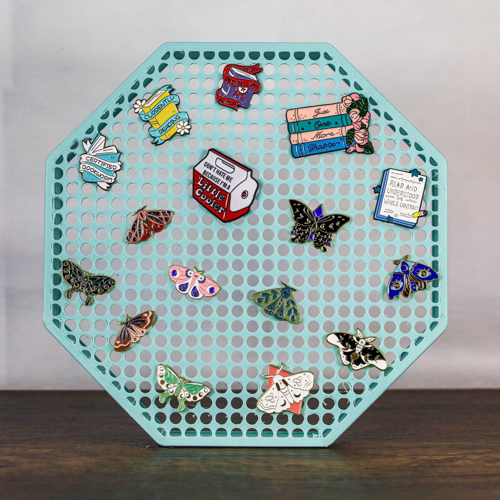 8" octagon enamel pin board display in turquoise with various enamel pins, wall mount or self-standing design
