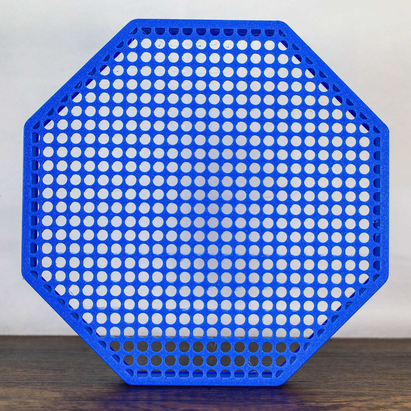 8" octagon enamel pin board display in blue with perforated surface for wall mounting or self-standing use