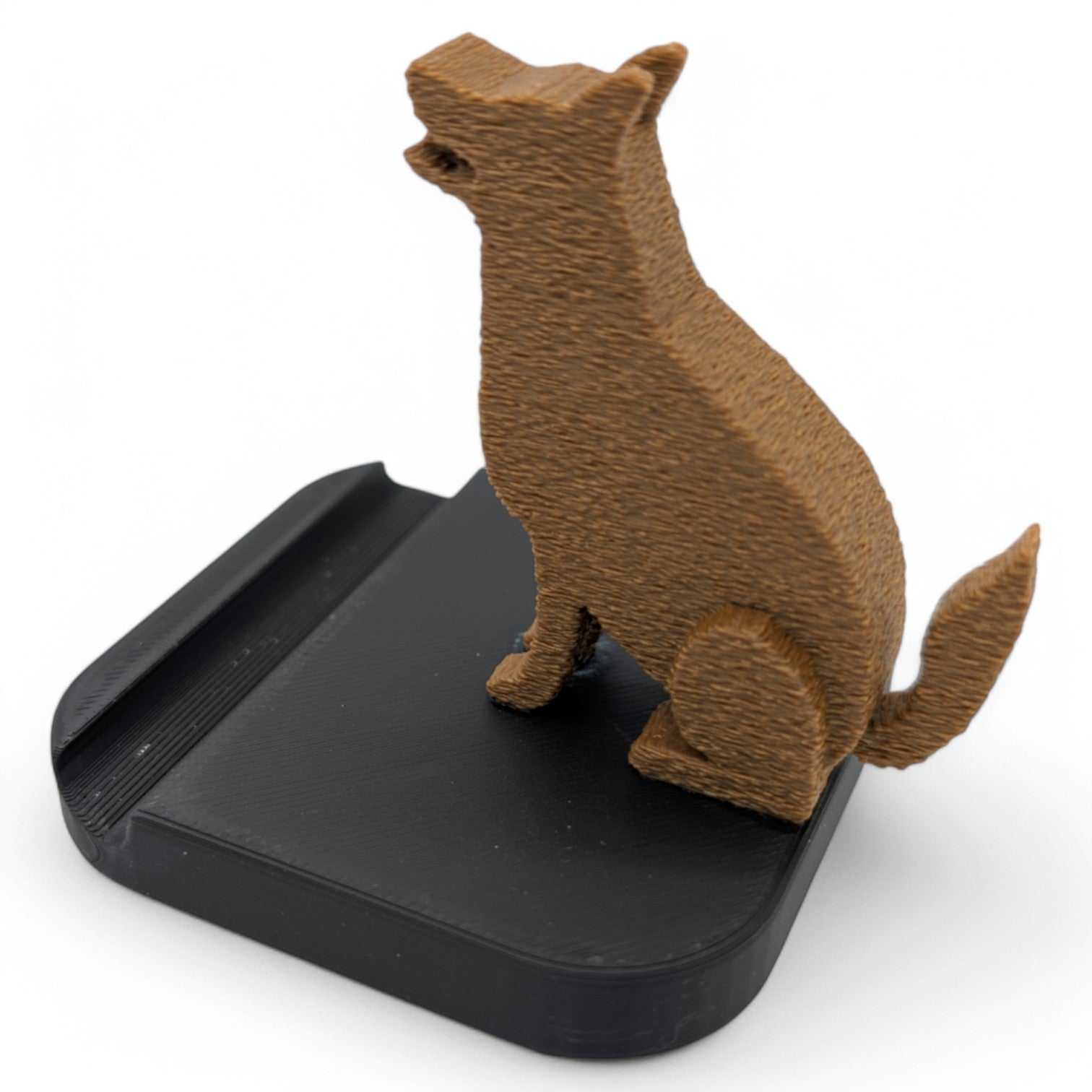 German Shepherd dog phone stand with brown dog figure on black base for holding smartphones upright.